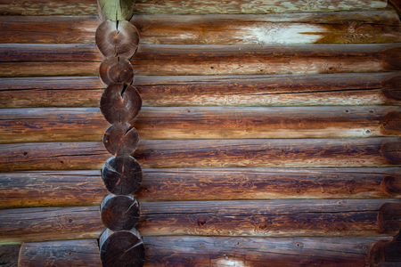 Old wood log background with cracks and lines. Light in the middle with space for copy, dark at the sides. Wall of house.の写真素材