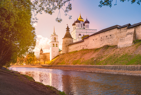 Pskov church and kremlin with blue cloudy sky in background. River in foreground.のeditorial素材