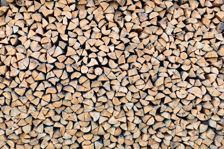 Stack of wood logs. Preparation of firewood for the winter. Pile of chopped lumber.の写真素材