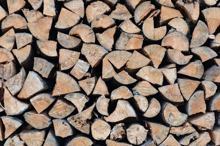 Stack of wood logs. Preparation of firewood for the winter. Pile of chopped lumber.の写真素材