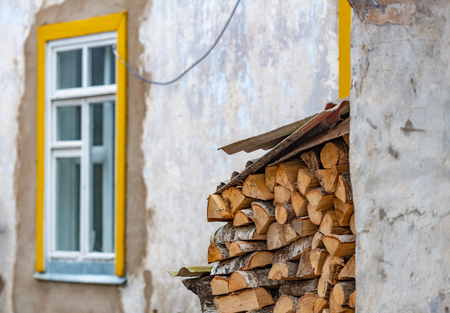 Stack of wood logs. Preparation of firewood for the winter. Pile of chopped lumber.