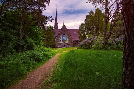 Old finnish church Koiviston kirkko in Primorsk city of Russia at sunset. Travel in europe.の写真素材