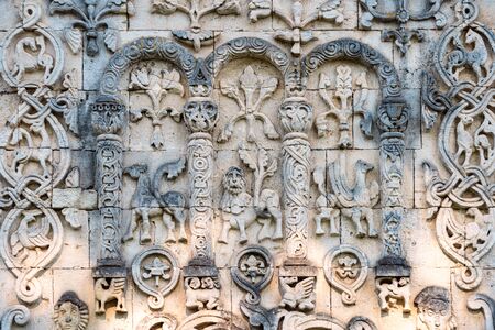 Big wall in church showing fictional characters. Primitive stone carving. Beautiful architecture of religious place. Tourist destination.の写真素材