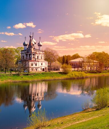 Old church in Vologda, Russia, Europe. Blue sunset sky in background and river in foreground. Travel and religion.の写真素材