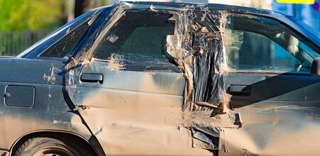 Damaged and smashed car after incident on road left at parking lot and waiting for repair or...