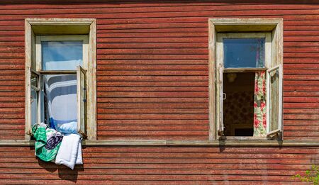 Old wood log background with cracks and lines. Windows on wall of house.の写真素材