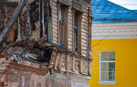 Old wood log house with cracks and lines. Windows on wall of house.の写真素材