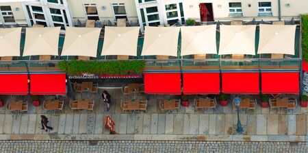 DRESDEN, GERMANY - SEPTEMBER 22, 2014: Top down view on street of Dresden, state of Saxony, Germany, Europe. Restaurant and people down below.の写真素材