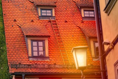 Old house roof with lies in germany, europe. Sunset scene with lantern light. Architecture and travel.の写真素材