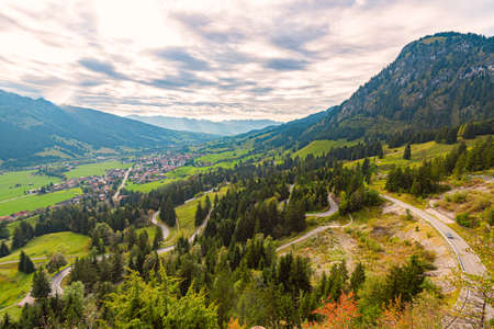 Car in mountains of Bavaria, Germany, Europe. Auto travel. Cloudy sky and miuntains in background.の写真素材