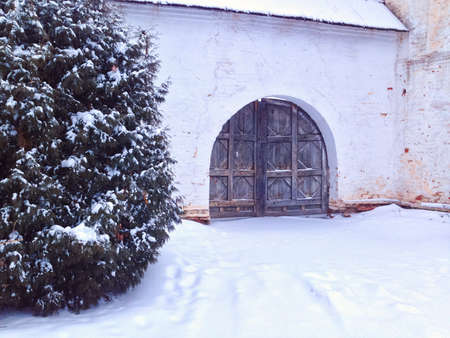 Old gate of monastery in winter. Lots of snow, Russia.