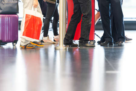 Airport hall with passengers in line. Modern style interior. Travelling and tourism.の写真素材