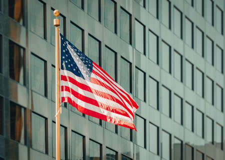 USA american flag and modern building in background