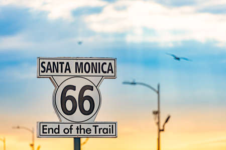 Santa Monica end of trail 66 sign. Highway from Chicago to Los Angeles, California. Sunset sky in background.の写真素材
