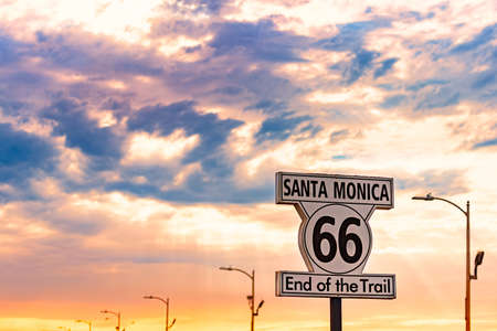 Santa Monica end of trail 66 sign. Highway from Chicago to Los Angeles, California. Sunset sky in...