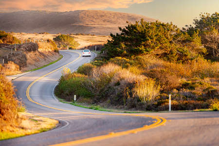 Car at highway, Big sur coast in California, United States of America. Mountains in background.の写真素材