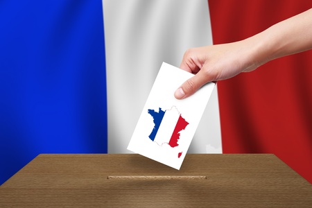 Hand with ballot and wooden box on Flag of Franceの写真素材