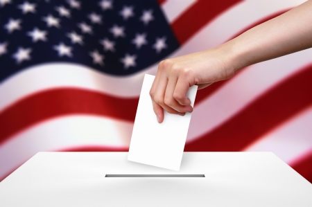 Hand with ballot and box on Flag of USA の写真素材