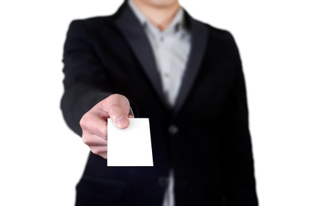 Business man handing a blank business card over white backgroundの写真素材