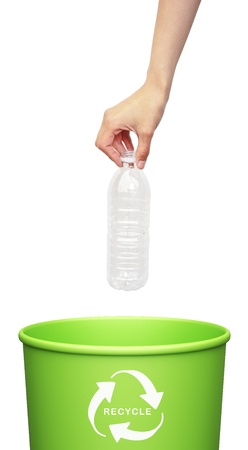 hand putting a plastic bottle into a recycling bin の写真素材