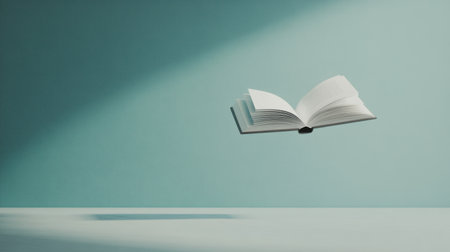 A floating white paperback book against a clean, monochromatic background, symbolizing creative concepts and boundless literary imaginationの素材