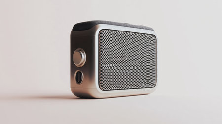 A portable Bluetooth speaker with a stylish, compact design, displayed against a white backdrop for music device advertising.の素材