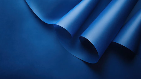 A captivating smooth blue paper background featuring elegant curves and soft shadows, ideal for creative projects, modern designs, and artistic presentations.の素材