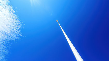 A pole vault setup standing tall against a clear blue sky.の素材
