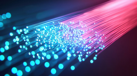 An advanced data center with fiber optic cables glowing in blue and red hues.の素材