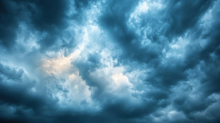 A dramatic silver sky before a thunderstorm, with dark clouds reflecting an ominous yet beautiful glow.の素材