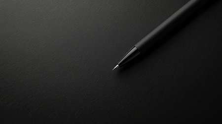 Elegant black pen and black paper in a vintage style. Minimalistic and stylish image perfect for writing and artistic concepts.の素材