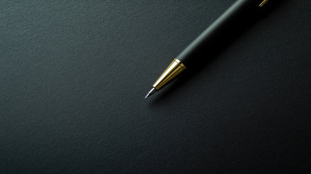 Stylish vintage black pen on black paper. Minimalistic and elegant image perfect for creative and writing concepts.の素材