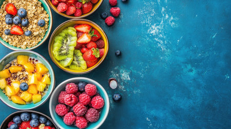 Vibrant bowls filled with fresh fruit and granola, neatly arranged on a table, creating a colorful and healthy breakfast scene with space for text.の素材