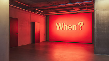 A large red "When?" question mark displayed on a wall, representing the unknown and the importance of timing. The stark design encourages reflection on future decisions or plansの素材