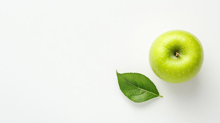 A bright green apple with a single leaf on a clean white background, symbolizing freshness and health. Ideal for nutrition, diet, or nature-related conceptsの素材
