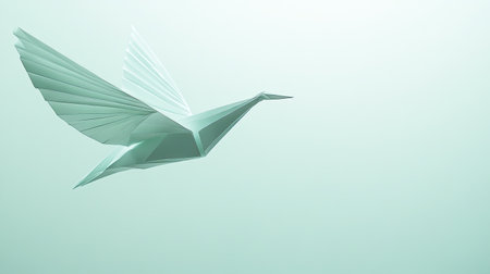 A delicate origami paper bird appears to be in mid-flight, set against a clean white background. The crisp folds and soft colors of the paper create a serene and artistic imageの素材