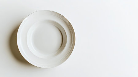 A classic ceramic soup plate isolated on a white background, showcasing its simple elegance with ample copy spaceの素材