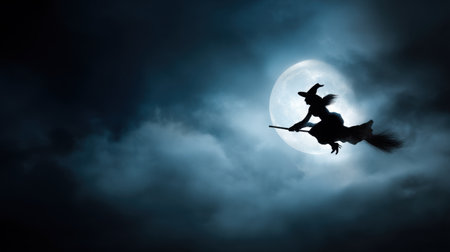 A captivating silhouette of a witch soaring through a dynamic night sky on her broomstick, with a luminous full moon casting an eerie light among the dark clouds.の素材