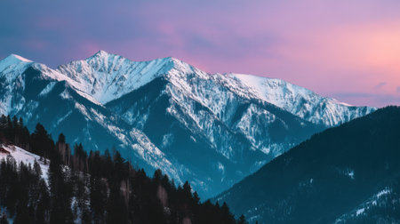 Stunning mountain landscape at dusk featuring snow-capped peaks, a colorful sky, and lush evergreen forests creating a tranquil and serene wilderness experience.の素材