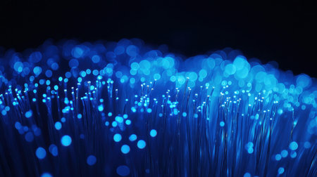 Thin light fiber optic strands in high-tech blue illumination, symbolizing modern internet technologyの素材