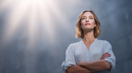 A confident woman stands in a thoughtful pose, showcasing inner strength and ambition, surrounded by a soft urban background and gentle light.の素材