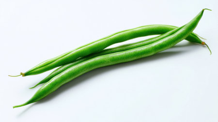 Capture the freshness of green beans placed on a clean white background. These vibrant vegetables are ideal for healthy meal preparation and add color to recipes. Perfect for those seeking nutritious ingredients.の素材