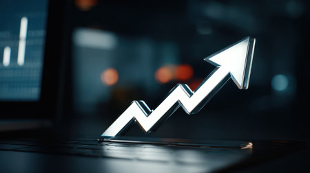 This image features a sleek 3D graph arrow symbolizing growth placed over a laptop keyboard, representing modern analytics and business progress.の素材
