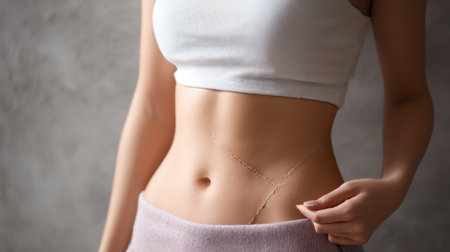 A stylish young woman displays her torso adorned with unique body art, embodying confidence and modern beauty. The casual vibe captures a blend of elegance and self-expression.の素材