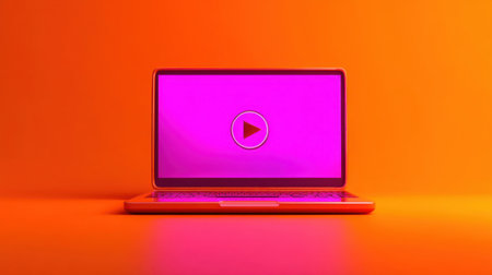 A sleek laptop featuring a prominent play button on a bright orange background, ideal for themes related to digital media, creativity, and innovation.の素材