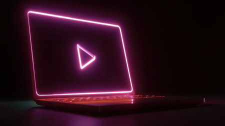A sleek modern laptop with a vibrant neon play button glowing against a dark background. Ideal for themes in media, digital content, and innovative technology.の素材