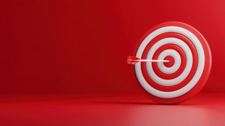 This image features a red target with white concentric circles, showcasing an arrow that strikes the center. Ideal for themes of focus, precision, and goal achievement in marketing and business contexts.の素材
