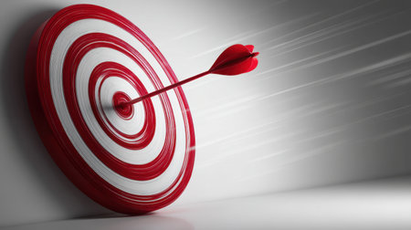 A striking image of a red dart perfectly hitting the center of a circular target, symbolizing precision and achievement in a dynamic setting.の素材