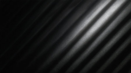 This image showcases a textured black background with soft diagonal light stripes, creating an elegant and modern visual. Ideal for design or artistic projects.の素材
