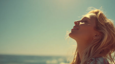 A young woman stands at the beach, embracing the sunlight and sea breeze with a blissful smile, reflecting joy and tranquility.の素材